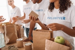 volunteers filing food in bags